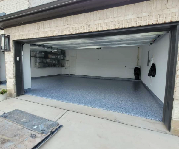Residential garage floor coated with durable gray epoxy floor coating by Mules Epoxy Coatings